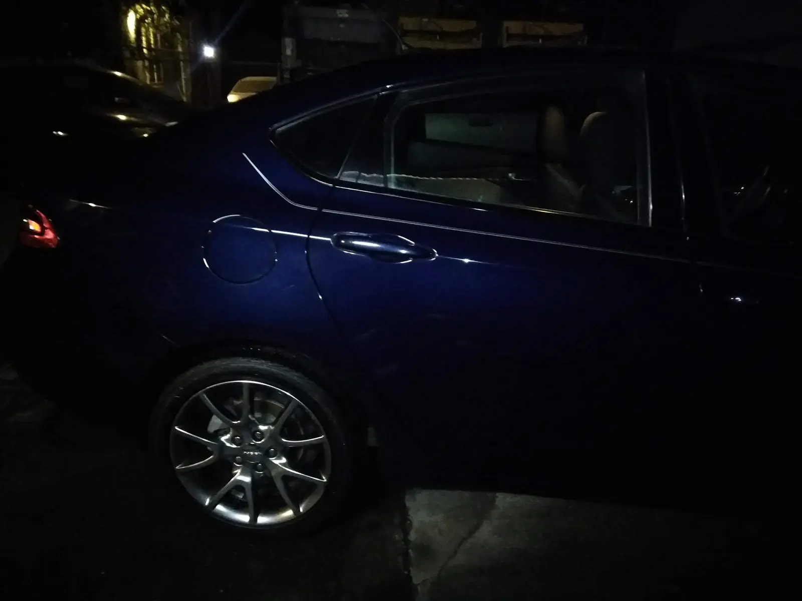 Dark blue sedan, exterior detail at night